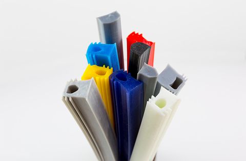 A bundle of Dry Seals silicone profiles in grey, black, white, blue, yellow and red, their ends showing the sections.