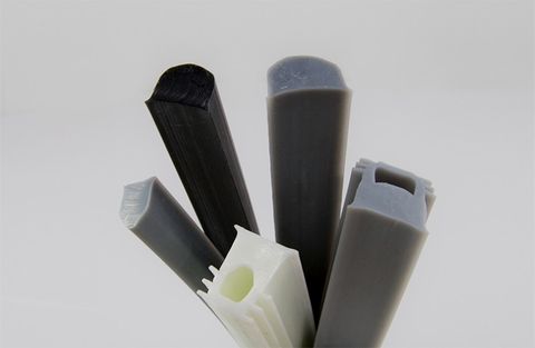 Dry Seals profiles in black, grey and white, their ends showing a hollow core and finned sides.